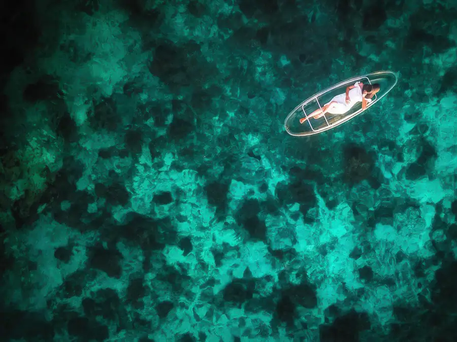 Guest enjoying a kayaking session in the turquoise sea near WB Shun Shun Water Bungalows