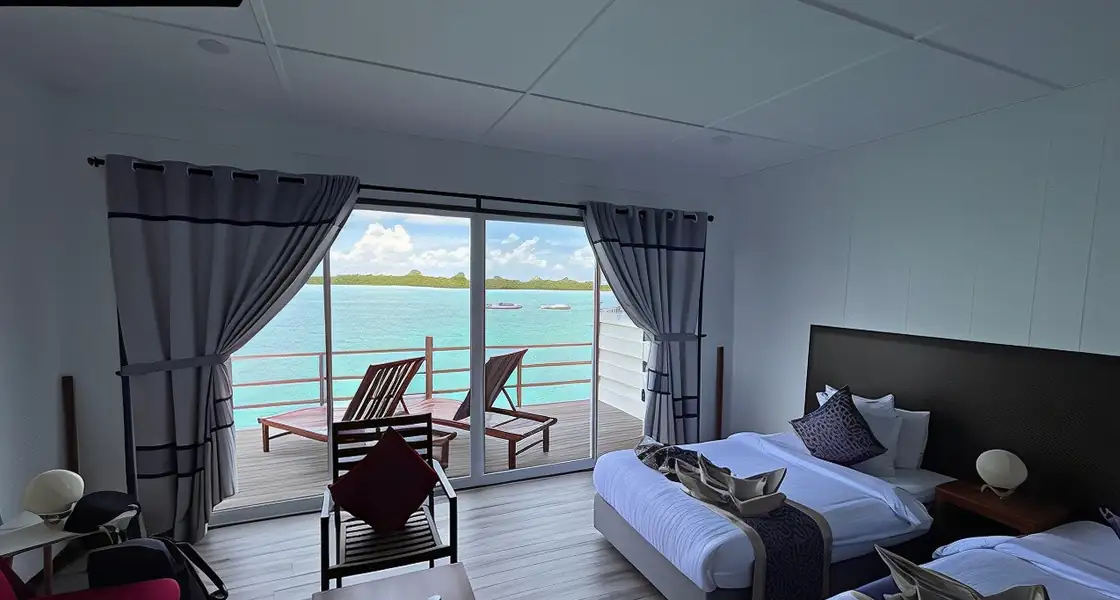 A beautiful twin bedroom at WB Shun Shun Water Bungalows with panoramic ocean views