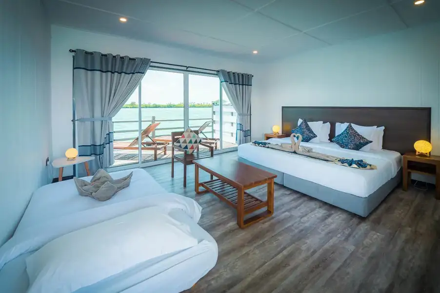 An inviting family bedroom at WB Shun Shun Water Bungalows facing the ocean